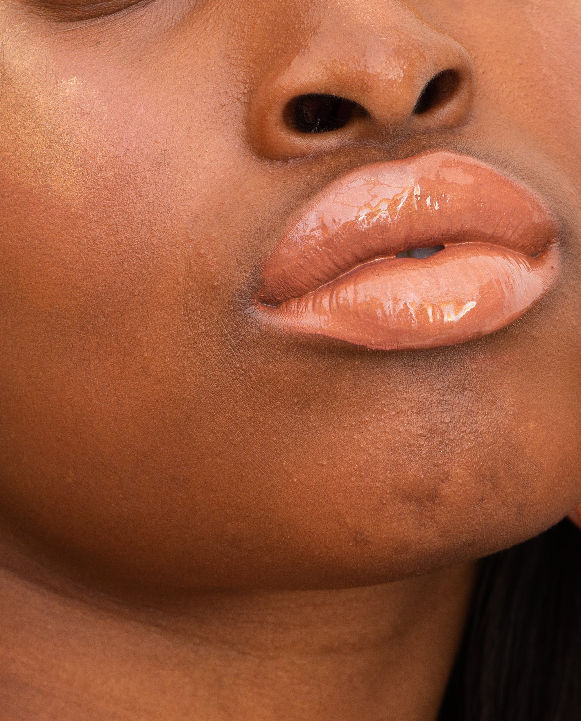 closeup of lip dew in sunlight on deep complexion